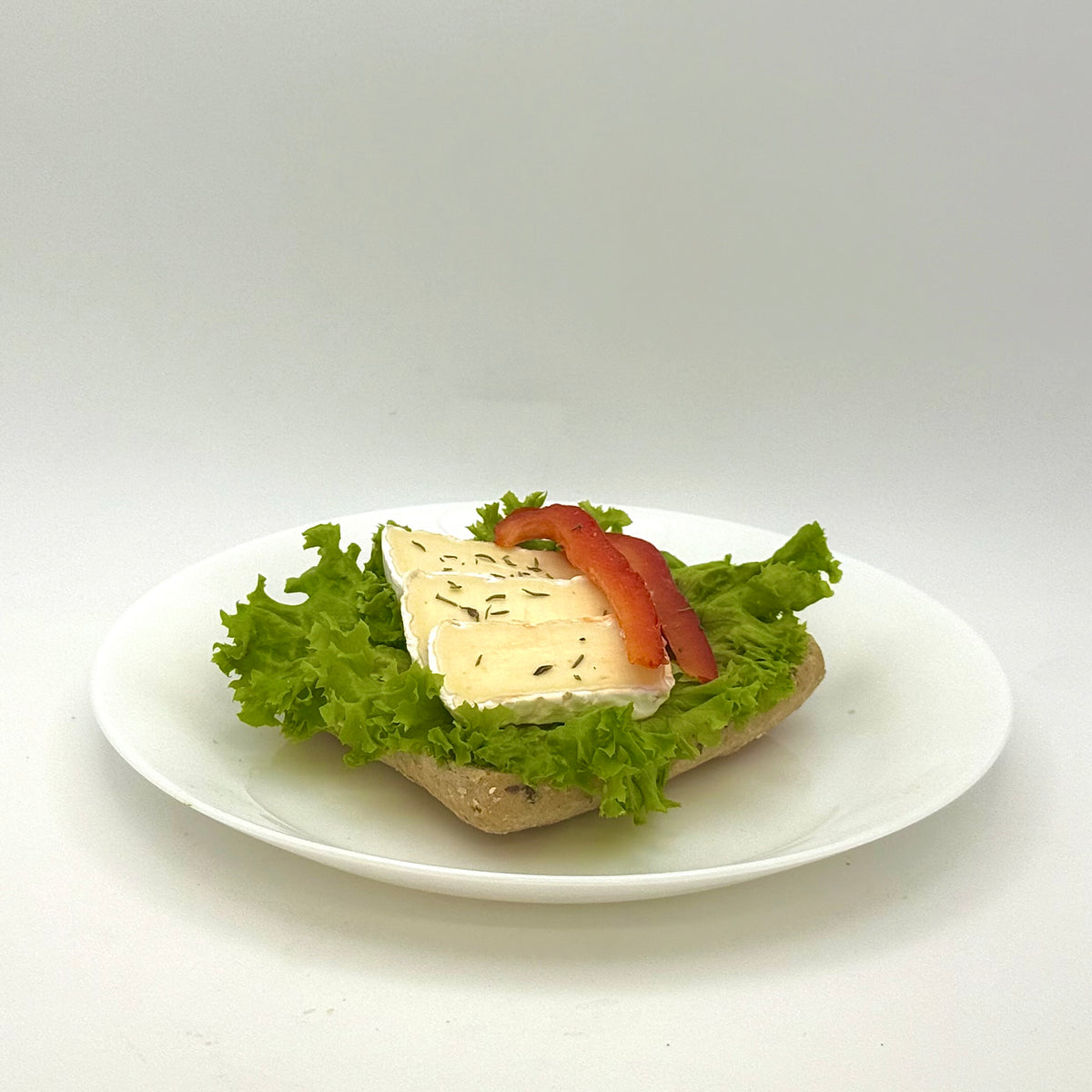 half a multigrain roll with Camembert cheese 