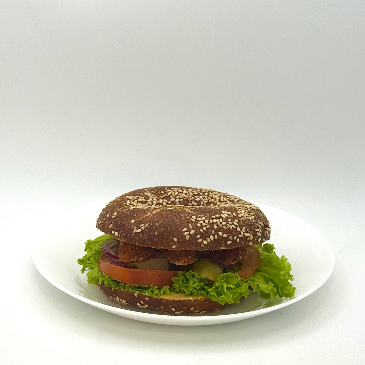 Pretzel bagel with crispy chicken and spicy cocktail mayo