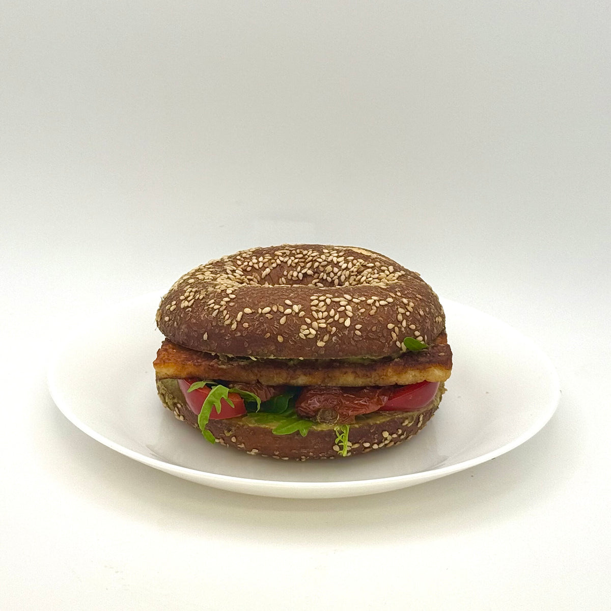 Pretzel bagel with grilled cheese, avocado cream