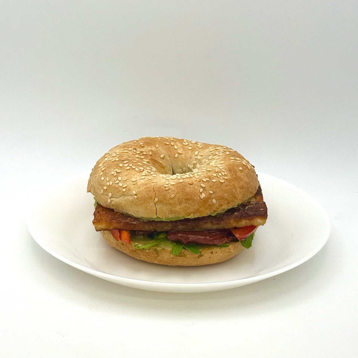 Sesame bagel with grilled cheese, avocado cream