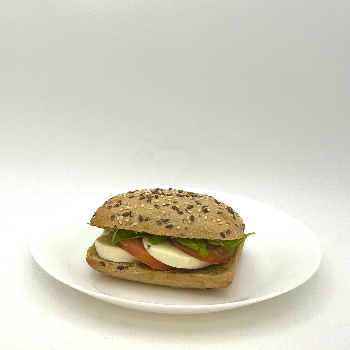 multigrain roll topped with mozzarella 