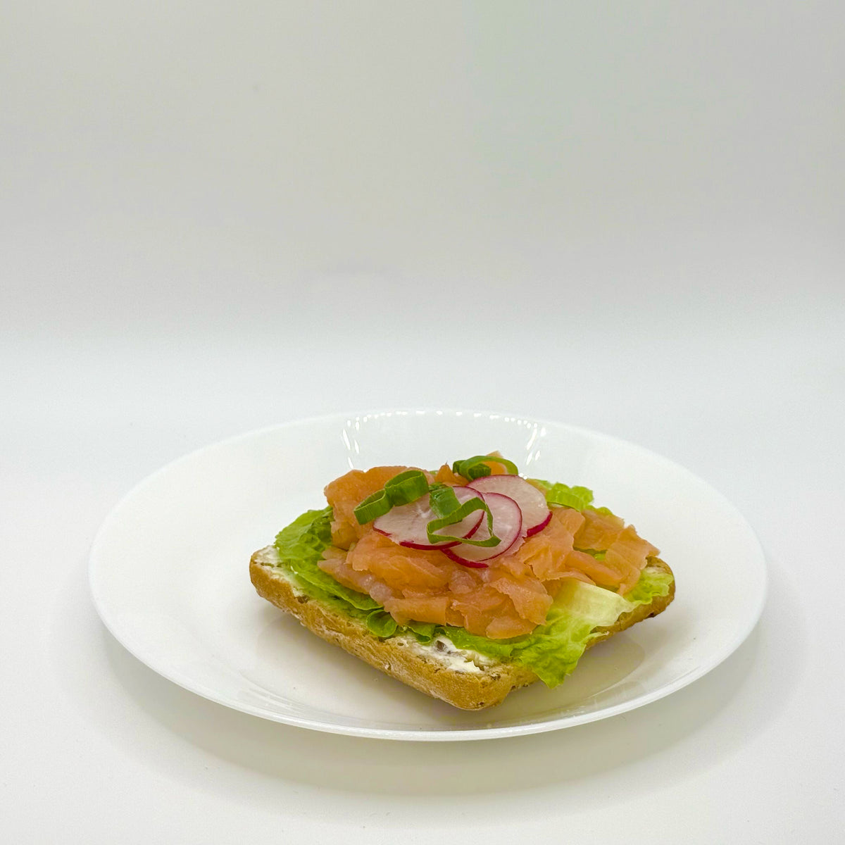 half a multigrain roll with smoked salmon 