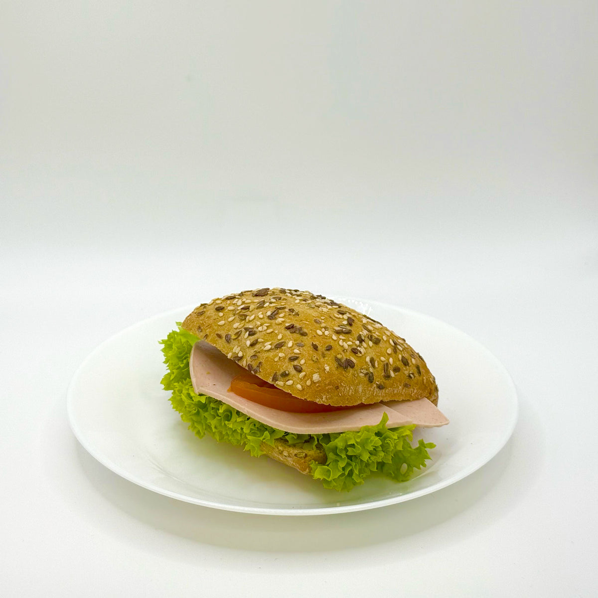 multigrain roll topped with turkey breast 